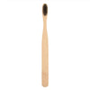A natural bamboo toothbrush with light wood color and bristles shown vertically.