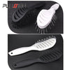 A set of black and white professional multi-function hair styling combs shown against a dark background.