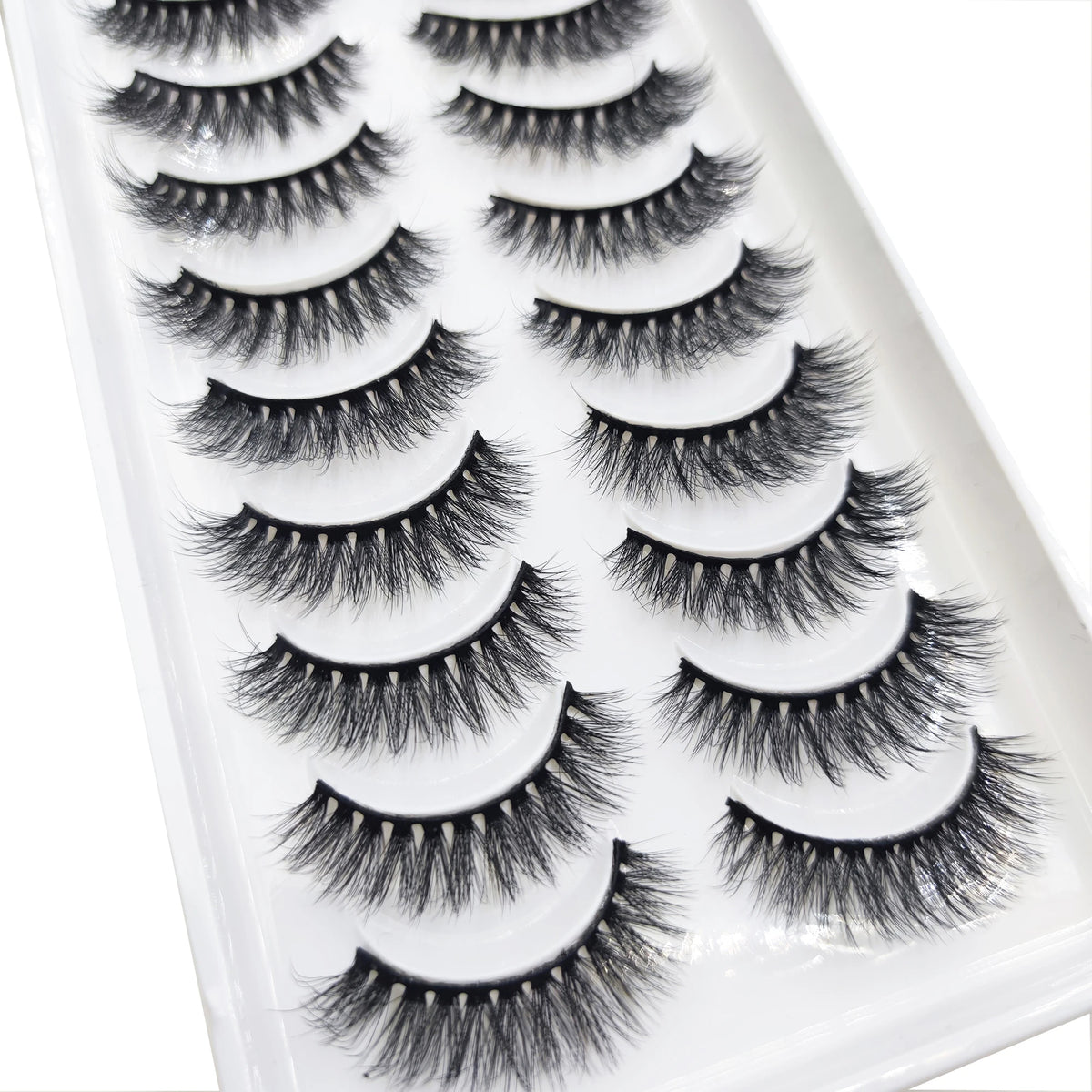 A tray of natural 3D mink false eyelashes displayed in a white plastic container.