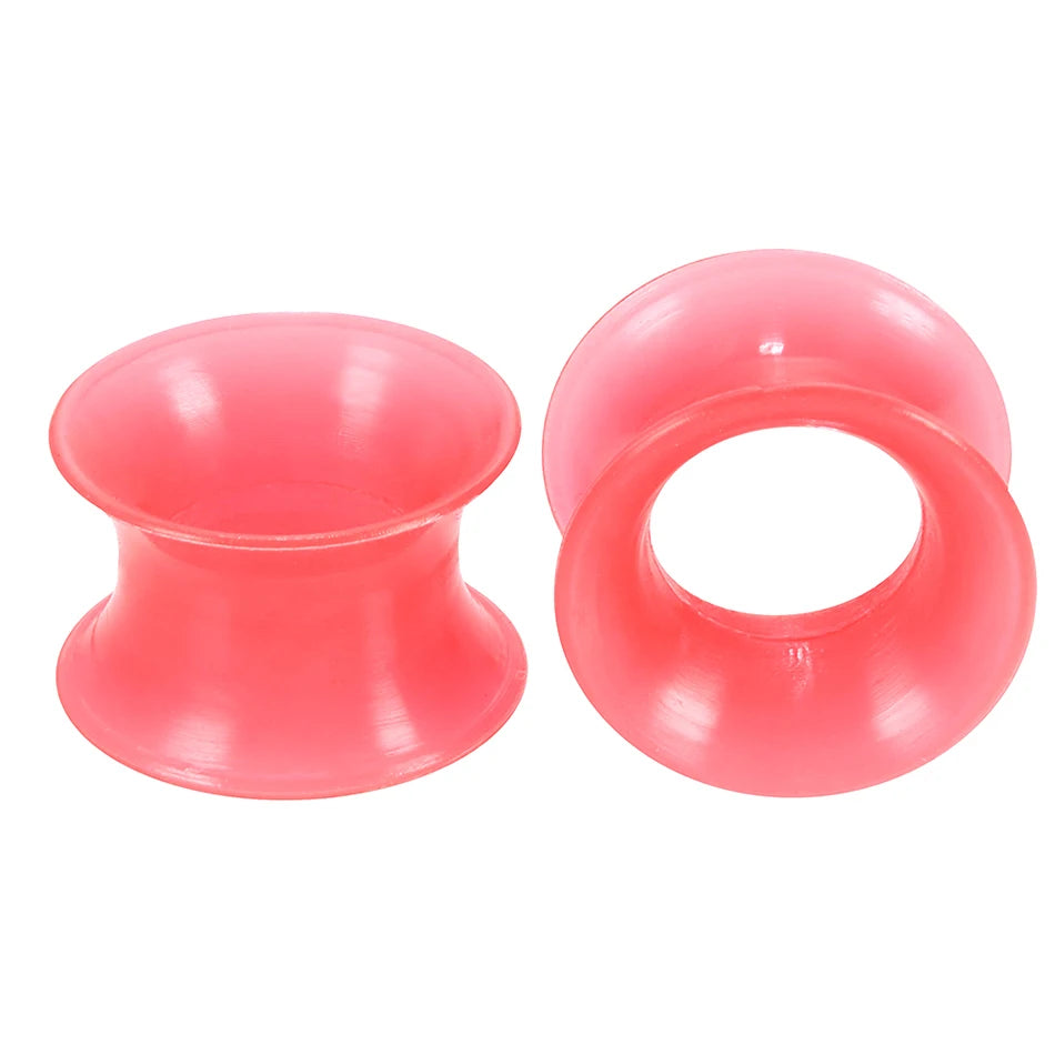 A pair of pink flexible silicone ear tunnels and plugs.