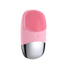 A pink sonic facial cleansing brush with a silicone head and a metallic base.