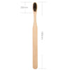 A natural bamboo toothbrush with bristles, shown against a white background.