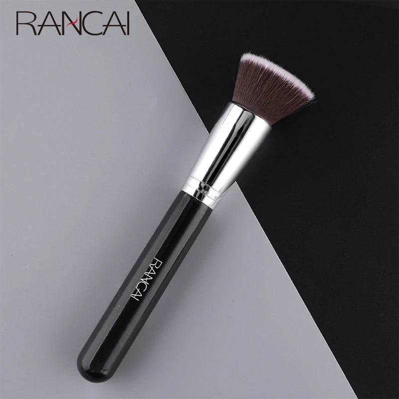 A black flat top kabuki foundation brush with a silver ferrule and a dense, dark brown synthetic hair bristles.