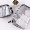 A clear waterproof travel cosmetic bag containing various white tubes and bottles for toiletries.