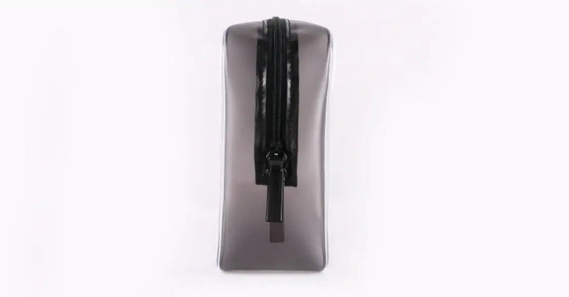 A dark gray waterproof travel cosmetic bag with a black zipper is shown against a white background.