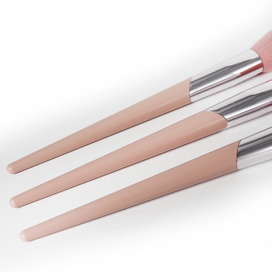 A set of pink angled cheek blusher makeup brushes with silver ferrules.