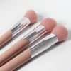 A pair of pink angled cheek blusher makeup brushes with silver ferrules shown against a white background.
