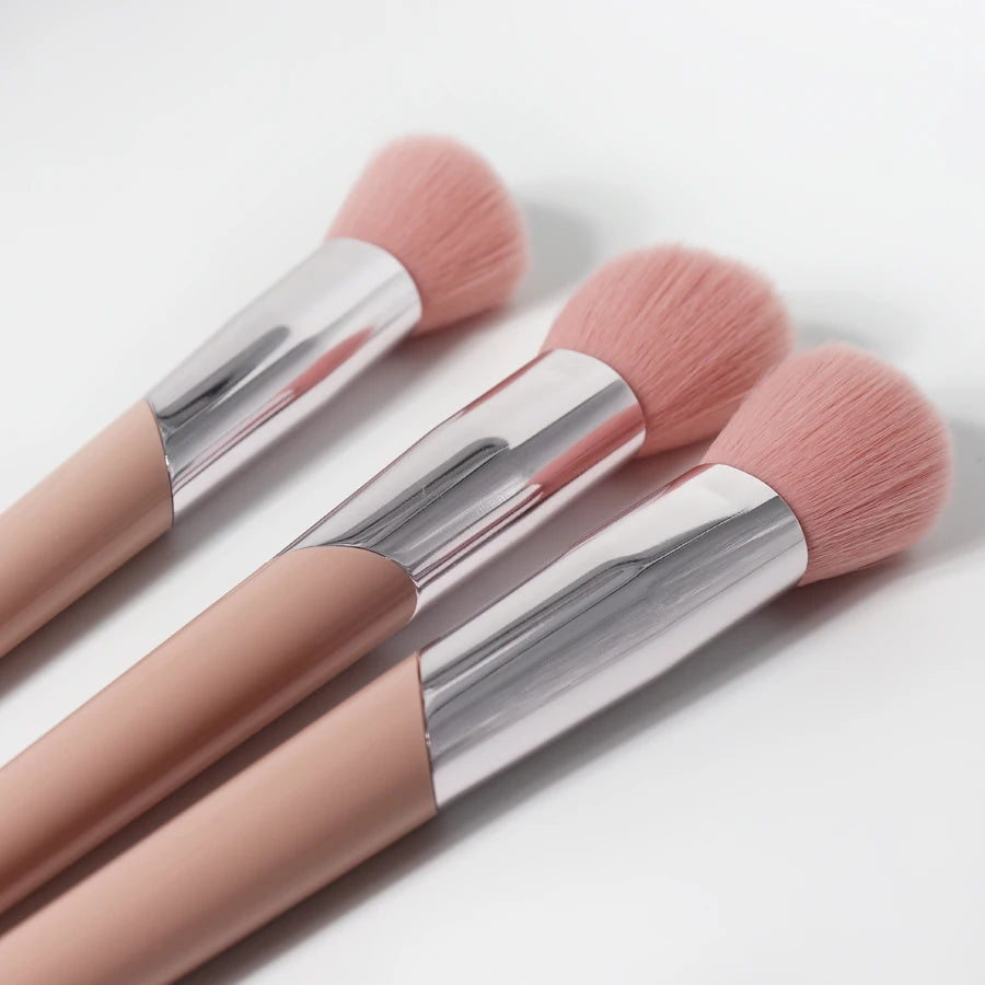 A pair of pink angled cheek blusher makeup brushes with silver ferrules shown against a white background.