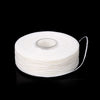 A spool of white mint flavored dental floss.