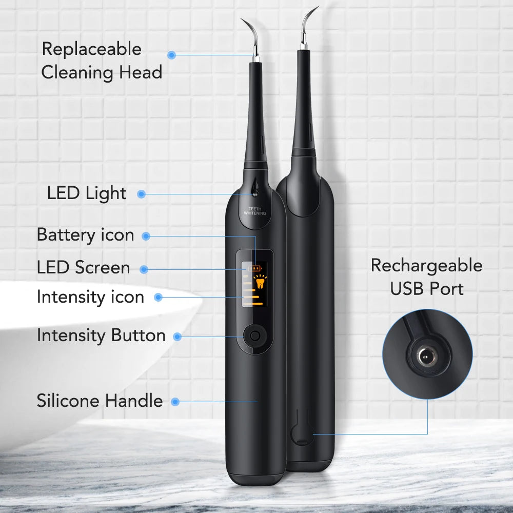 A black electric dental scaling and whitening tool with a silicone handle and rechargeable battery is shown on a white surfac