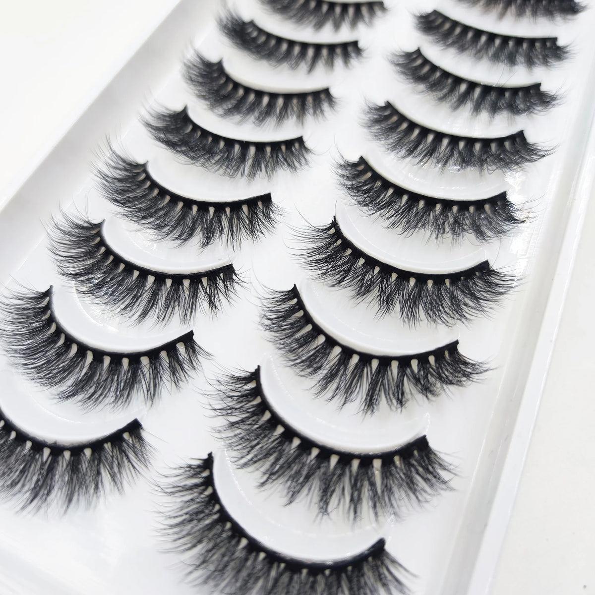 A tray of natural 3D mink false eyelashes displayed on a white background.