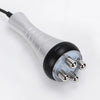 A silver and black ultrasonic body sculpting massager with multiple metal prongs visible at the end.