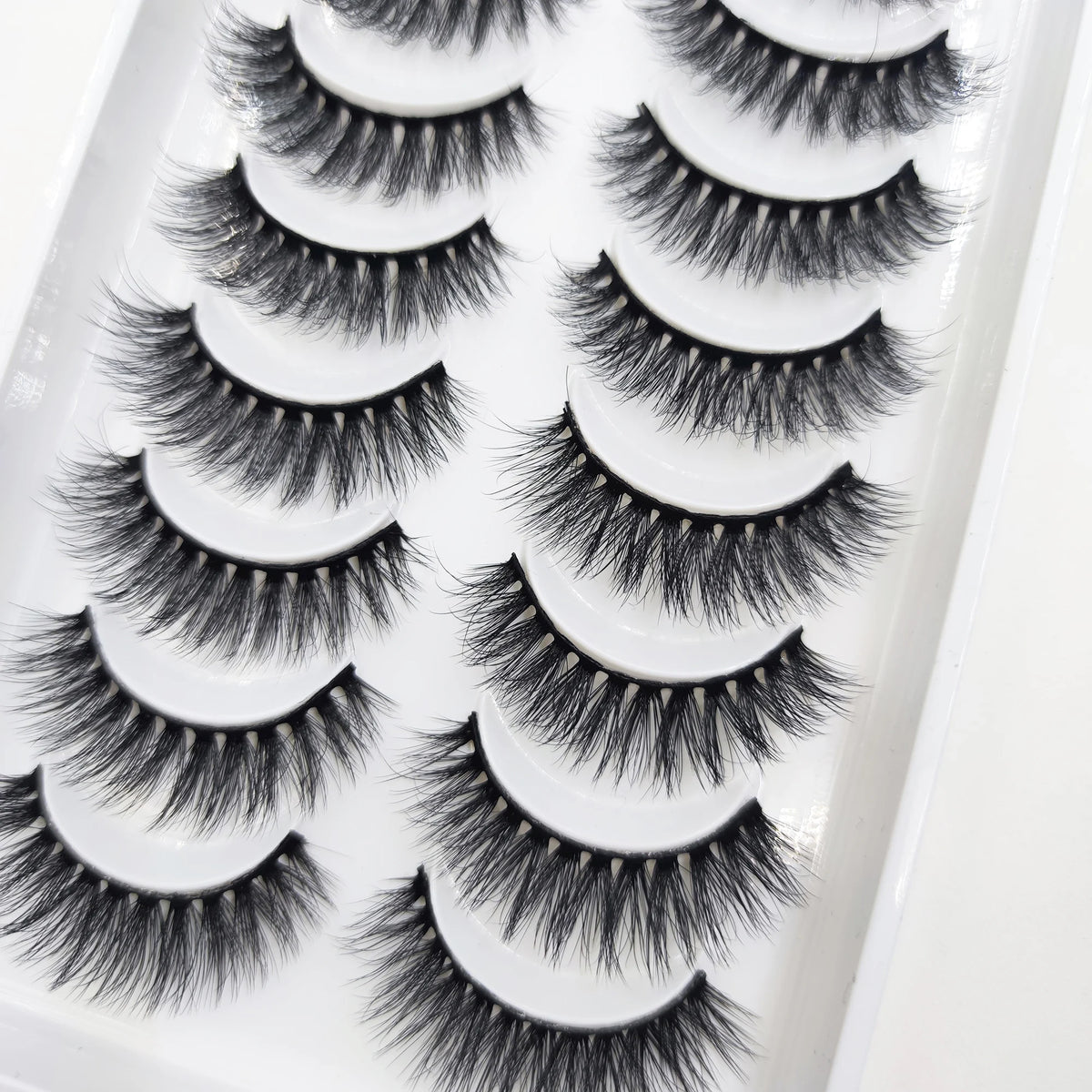 A tray of natural 3D mink false eyelashes displayed for sale.