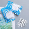 A package of disposable dental floss picks for oral hygiene showing multiple white picks.