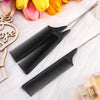 A set of black stainless steel rat tail hair combs displayed on a white surface with pink and yellow flowers.