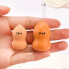 A hand holds a dry and wet makeup sponge puff, showing the difference between the two textures.