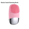 A pink electric facial cleansing brush with a silver head and body.