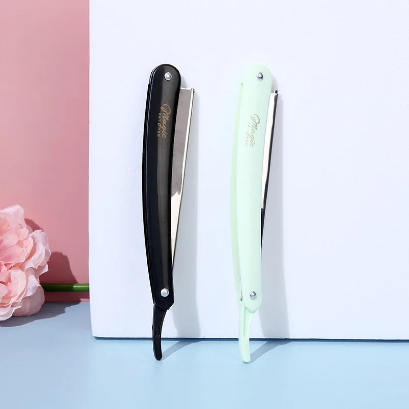A black folding straight razor shaver with a silver blade and a light green handle is displayed against a white background.