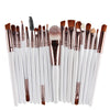 A collection of 20 professional makeup brushes with wooden and synthetic bristles arranged in a row.