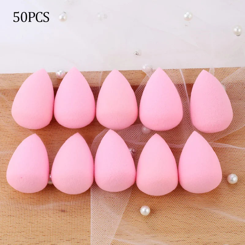 50 pieces of pink makeup sponge puffs arranged on a sheer mesh background