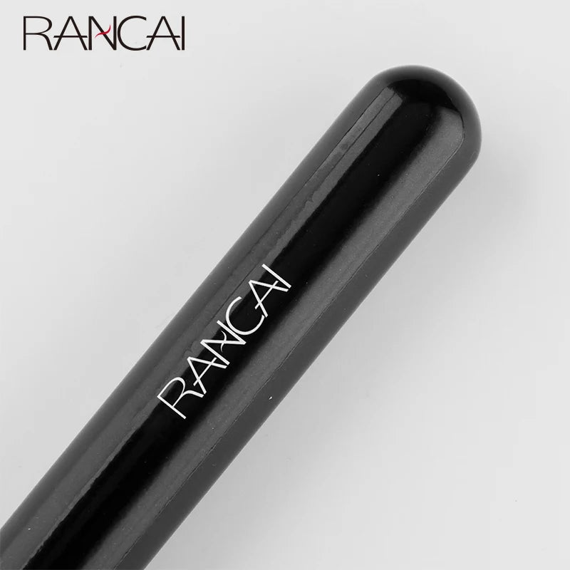 A black flat top kabuki foundation brush with the brand name RANCAI visible on the handle.