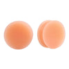 A pair of flexible silicone double flared ear tunnels in a peach or light orange color.