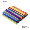 A fan of colorful wooden nail art pusher sticks arranged diagonally.
