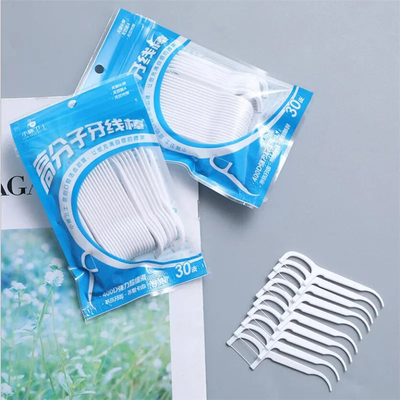 Packaged dental floss picks for oral hygiene tool with white floss and packaging visible.