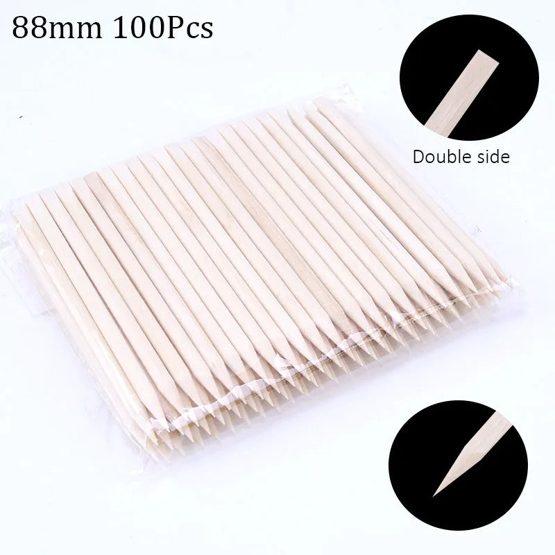 A flat arrangement of 100 natural wood nail art pusher sticks, showing the double-sided design.