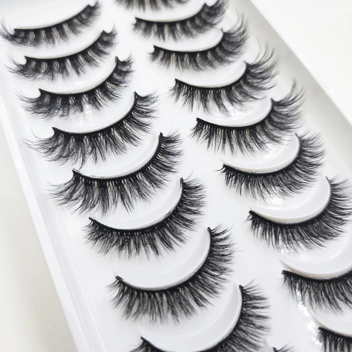 A display of natural 3D mink false eyelashes in various styles and lengths.