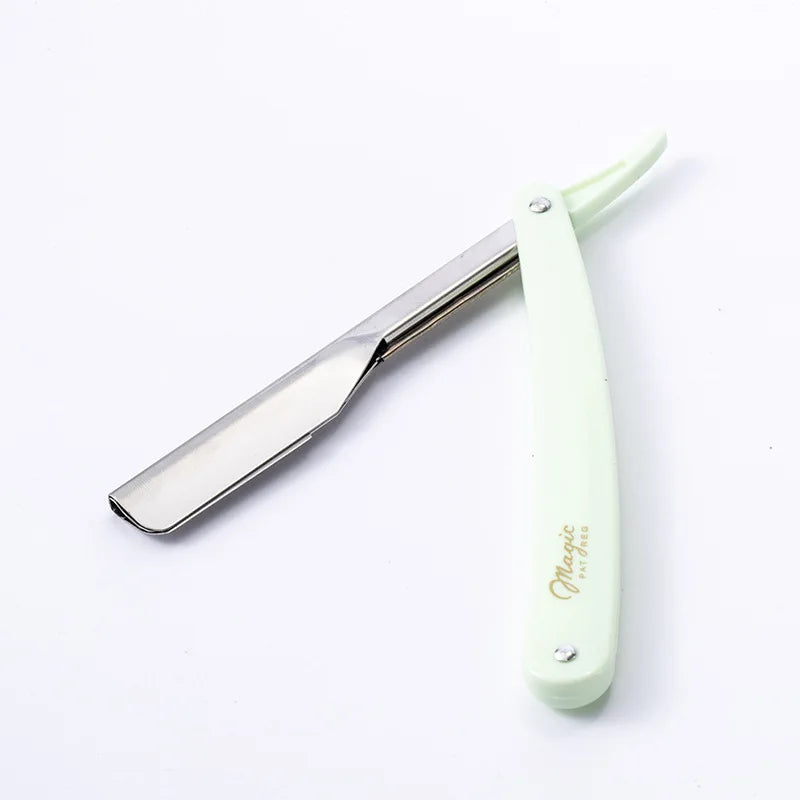 A silver folding straight razor shaver with a light green handle and blade visible.