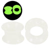A set of flexible silicone ear tunnels and plugs, including a green and an orange color.