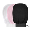 A set of three exfoliating body scrubbing gloves in white, pink, and black.