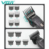 A set of VGR electric hair and beard trimmers showing various sizes of cutting combs.