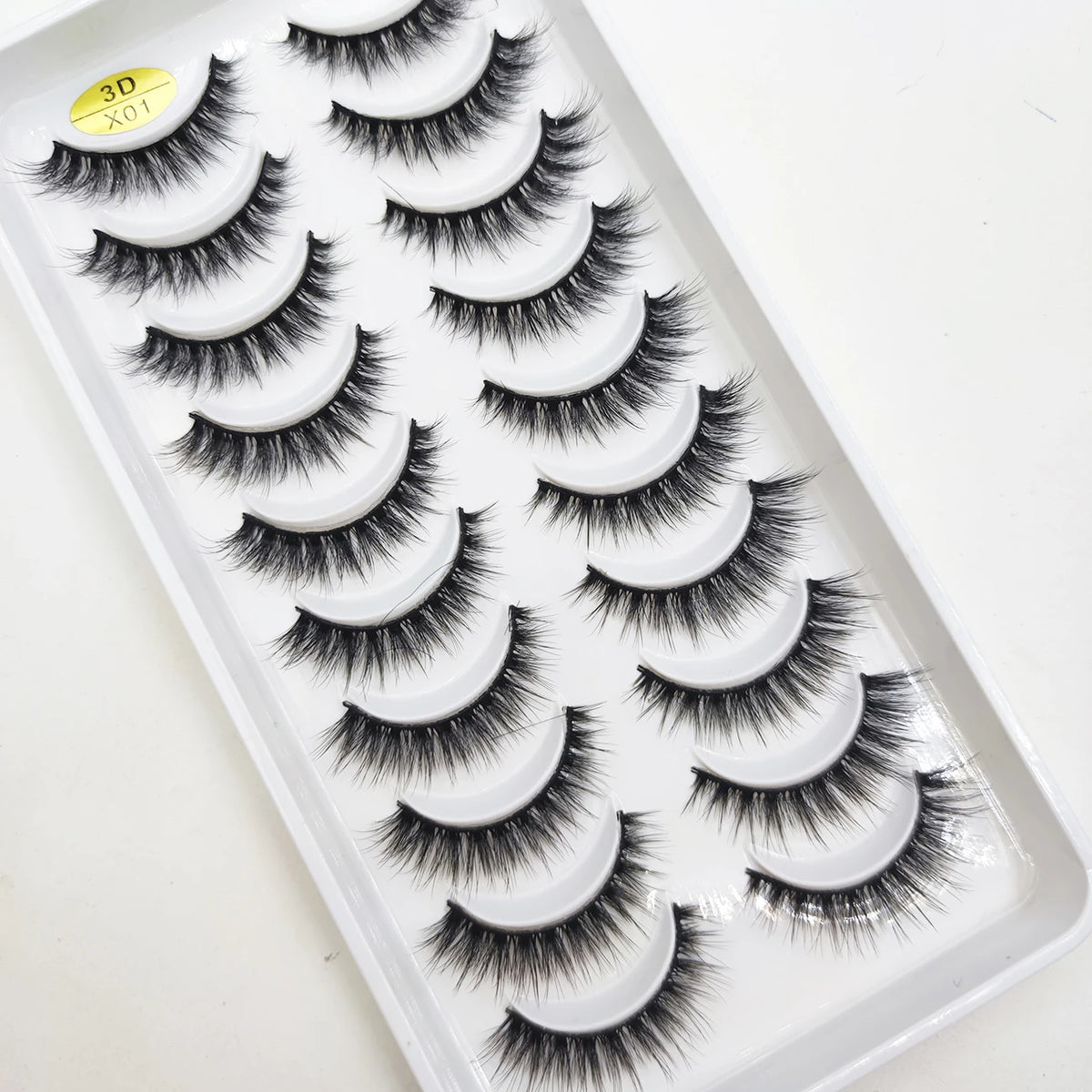 A tray of natural 3D mink false eyelashes displayed on a white background.