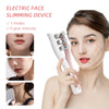 A woman is using an electric face slimming device with roller attachments on her face.