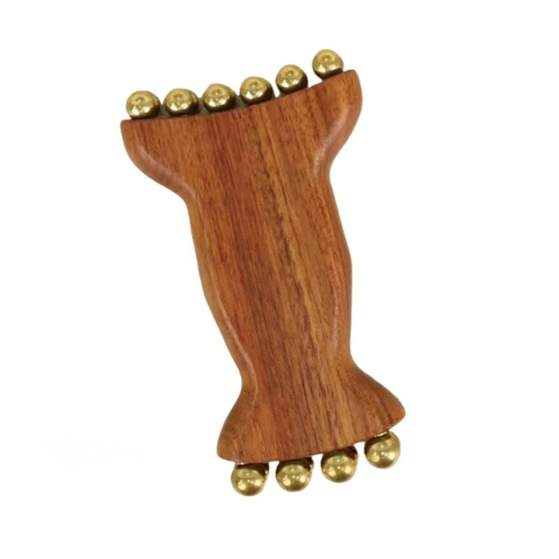 A natural wood facial and scalp massage comb with small metal balls on the top and bottom.