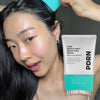 A woman is shown using a PDRN Reedle Shot Brush Hair Serum product for scalp care.
