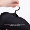 A hand is shown using a hook to access the interior of a black wig storage bag.
