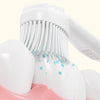 Brosse à dents mini portable blanche avec poils étendus, posée sur une base rose.