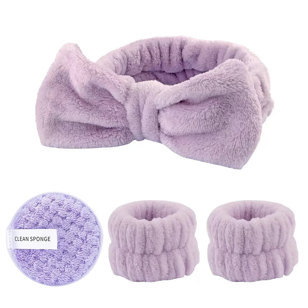 A lavender faux fur brush set including a large bow and two round sponges.