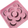 A pink plastic tray holding various artificial mink eyelashes for eye makeup application.