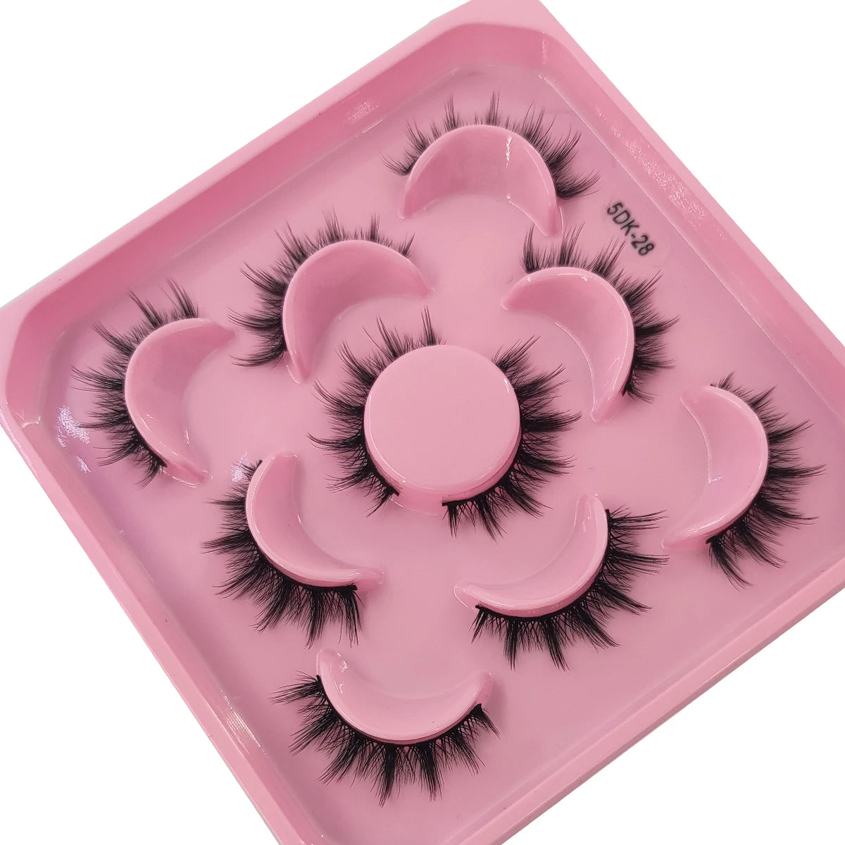 A pink plastic tray holding various artificial mink eyelashes for eye makeup application.