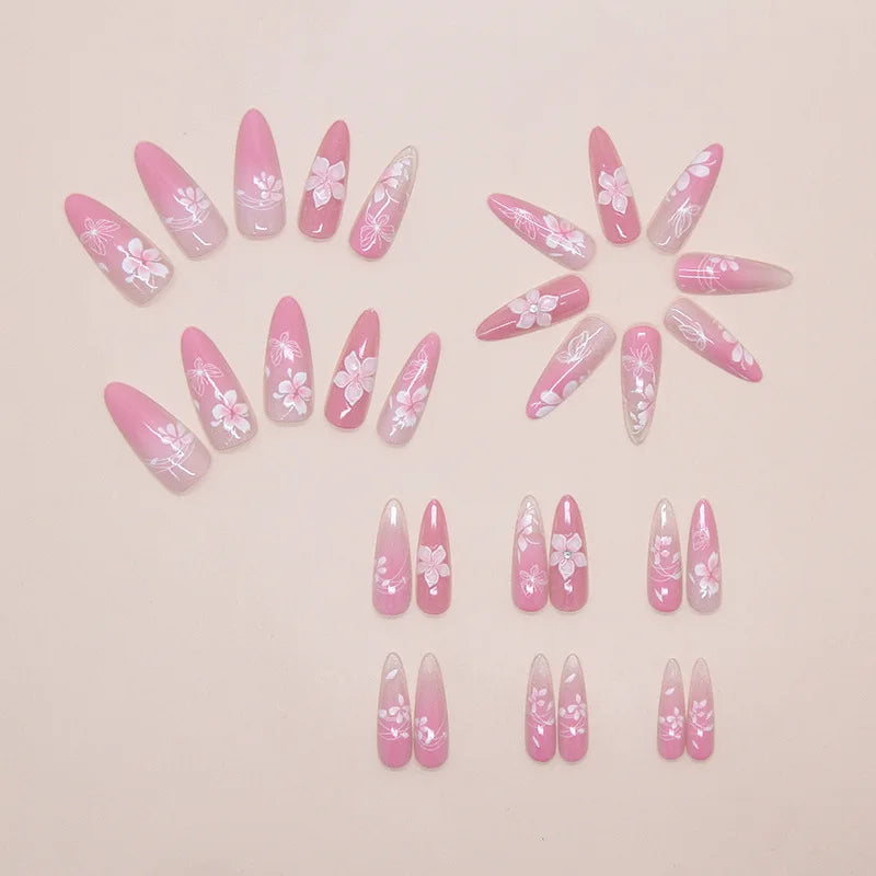 A collection of pink cat eye false nails featuring 3D floral and butterfly designs arranged in a circular pattern.