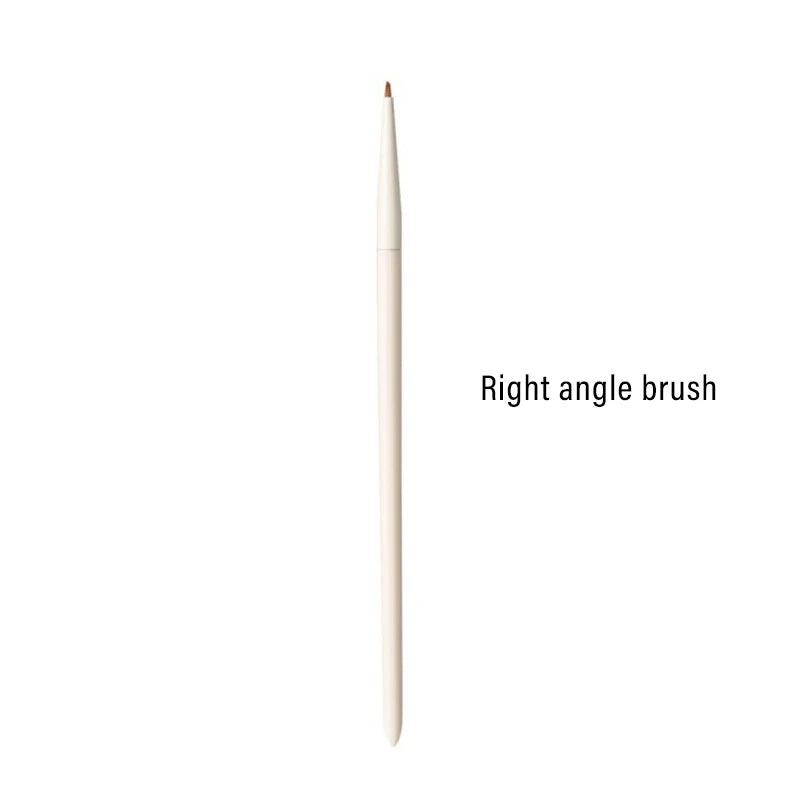 A single, light-colored right angle makeup brush for eyeliner and eyebrow application.