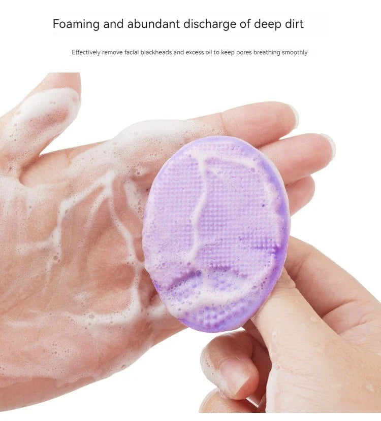 A hand is using a purple silicone facial cleansing brush to foam and remove deep dirt from the skin.