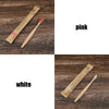 A set of eco-friendly bamboo toothbrushes in pink and white colors shown on a wooden surface.
