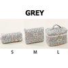 Grey quilted cotton makeup bags in sizes S, M, and L with floral patterns.