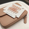 A set of pink handmade press-on nails with a French almond shape displayed on a card.