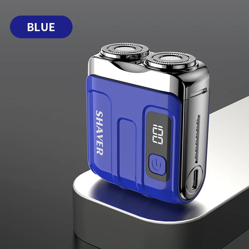 A blue mini electric shaver resting on a gray surface.